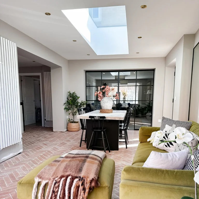 A frameless rooflight above a dining and living space