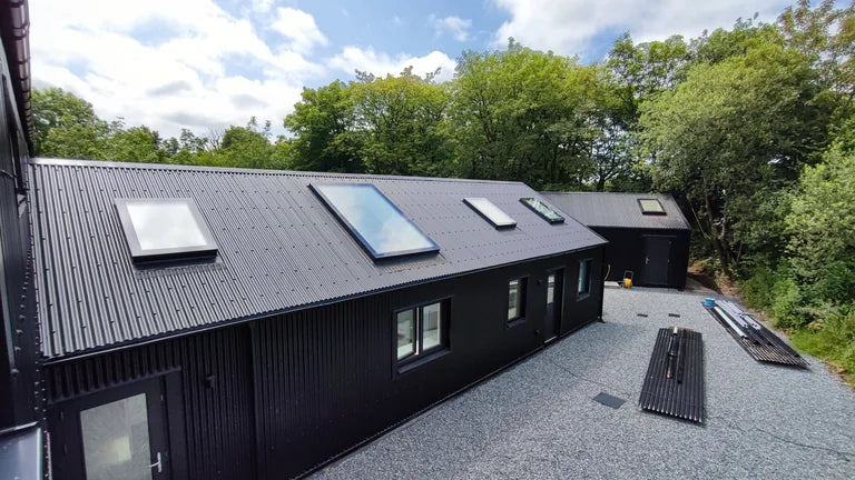 A series of HorizonLite rooflights installed on a pitched corrugated metal roof